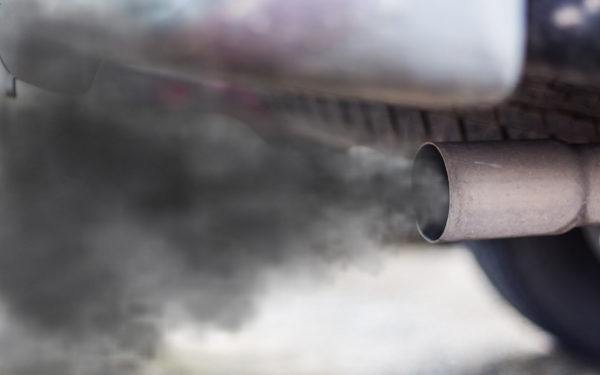 An exhaust pipe is shown spewing out black smoke