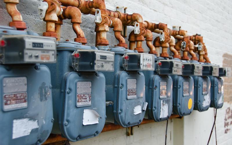 a row of gas meters on the side of a building