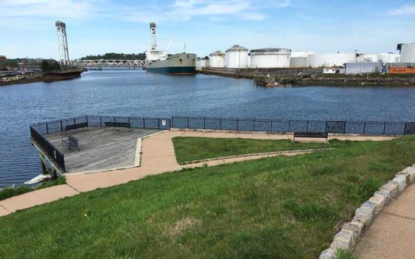 The waterfront site near the dangerous electric substation proposed by Eversource in the Eagle Hill community in East Boston. The jet fuel tanks and other infrastructure in the background highlight the need for climate justice in this community.