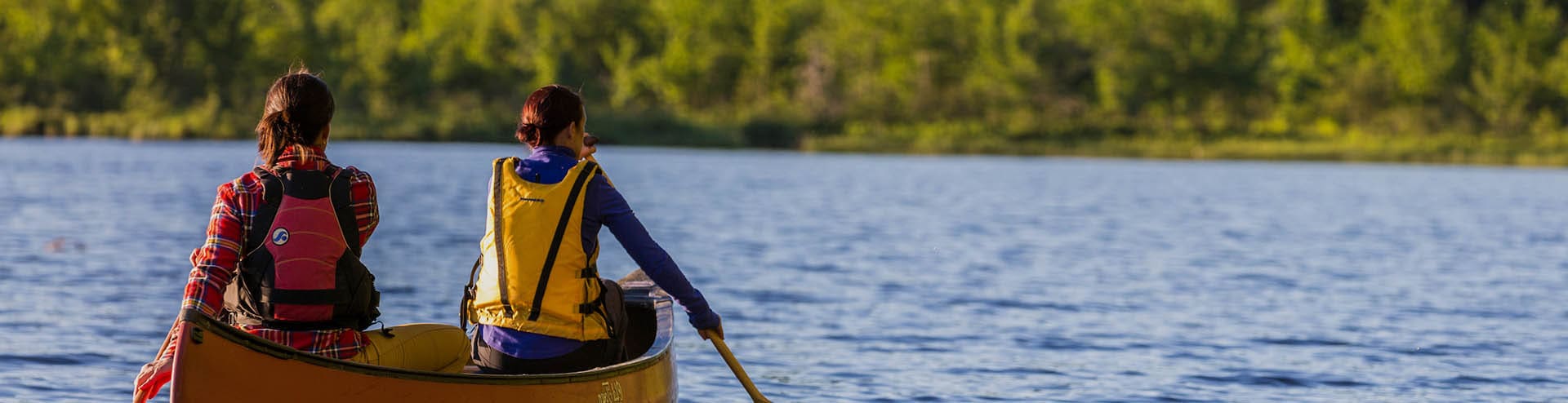 Two people canoeing on a spring day