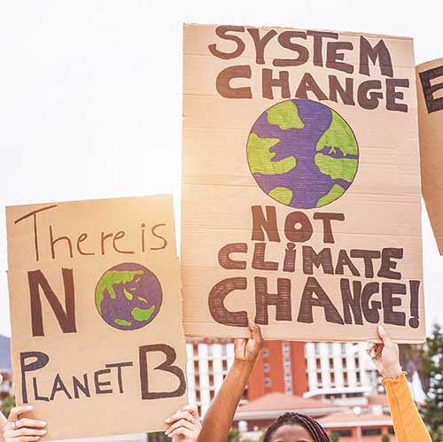 Protest sign that says "System change not climate change"