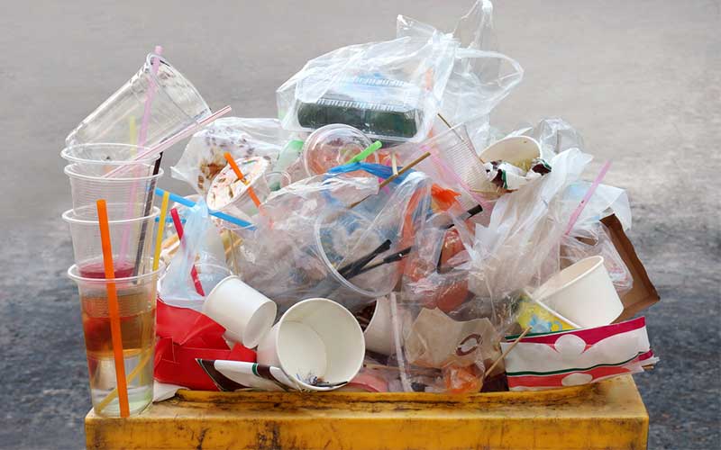 trash can filled with plastic waste