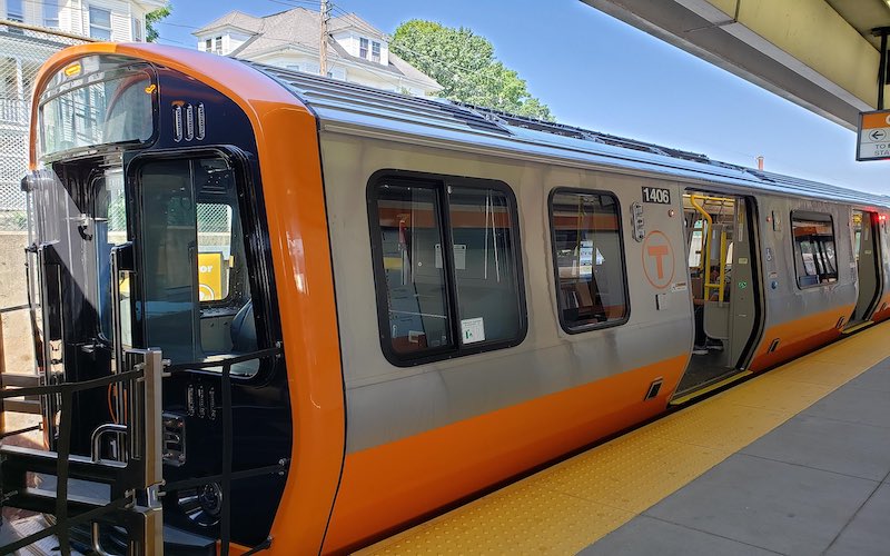 A new MBTA Orange Line train waits at a station