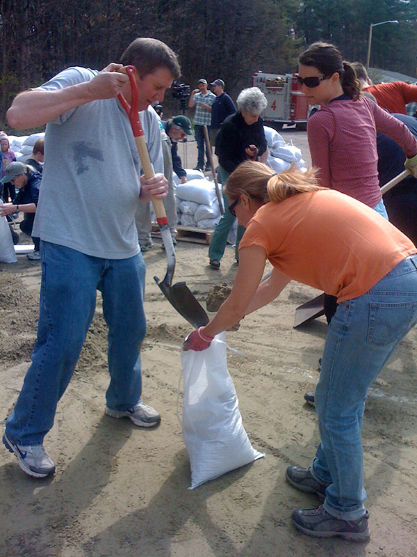 Volunteers fill sandbags