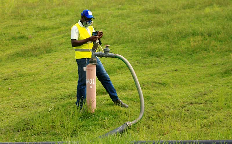 A worker monitors landfill gas