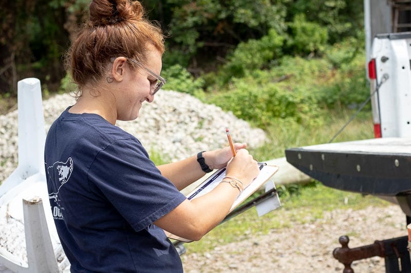 Blue Ocean Society staff holds clipboard to tally the items collected during the Great Bay cleanup.