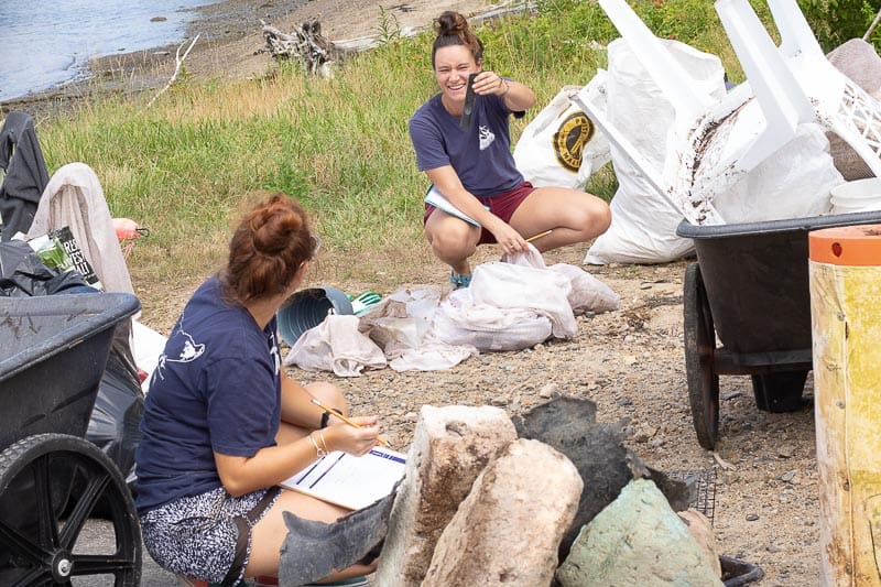 Piece by piece, the team from the Blue Ocean Society tally the trash items in the mesh bags.