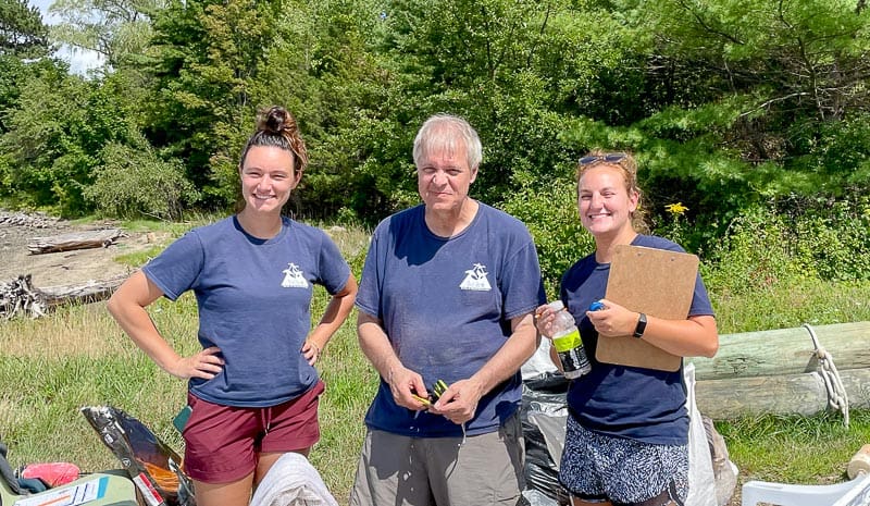 Blue Ocean Society staff surrounded by trash bags from Great Bay cleanup.