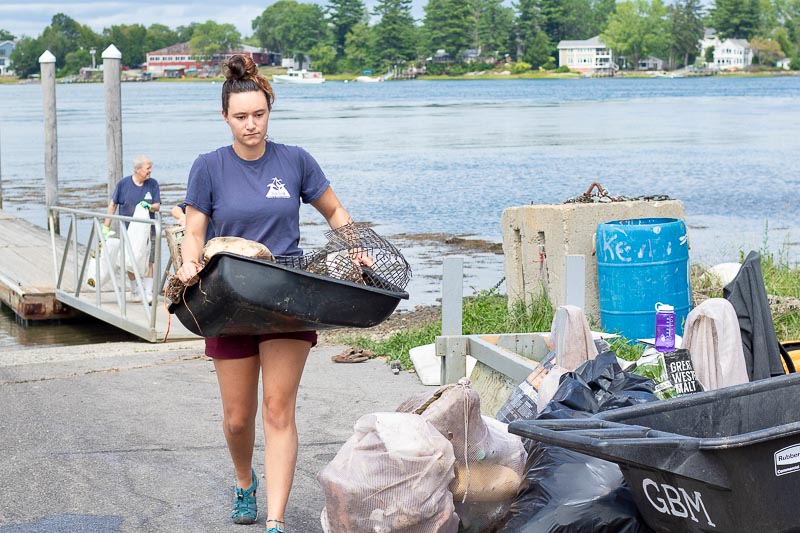 Blue Ocean Society team unloads trash bins at the Marina's deck.