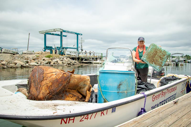 Melissa Paly, Great Bay-Piscataqua Waterkeeper, unloads marine debris on Marina's deck.