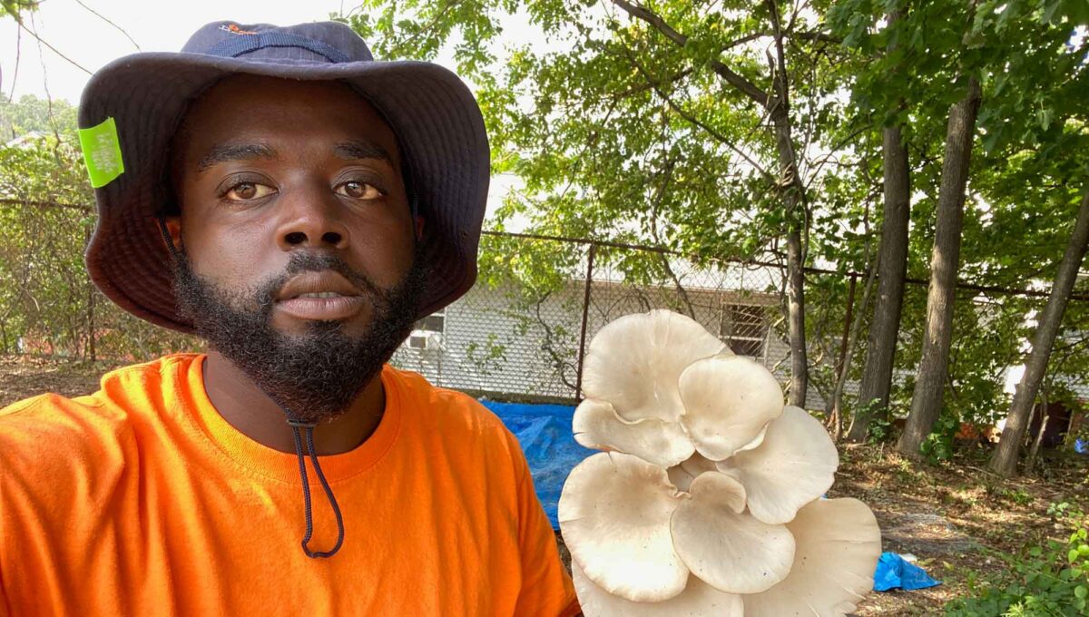 Robert Peck holding a mushroom
