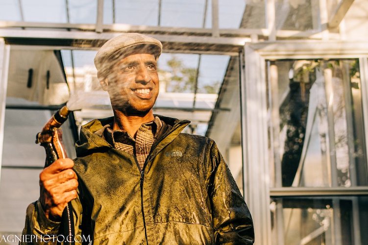 Kannan Thiruvengadam stands outside the Eastie Farm greenhouse.