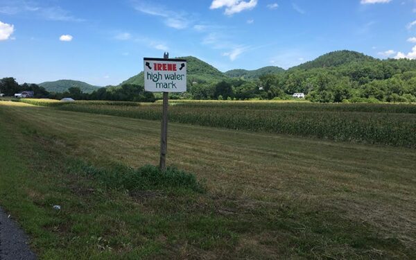 A field with a sign reading "Irene high water mark."