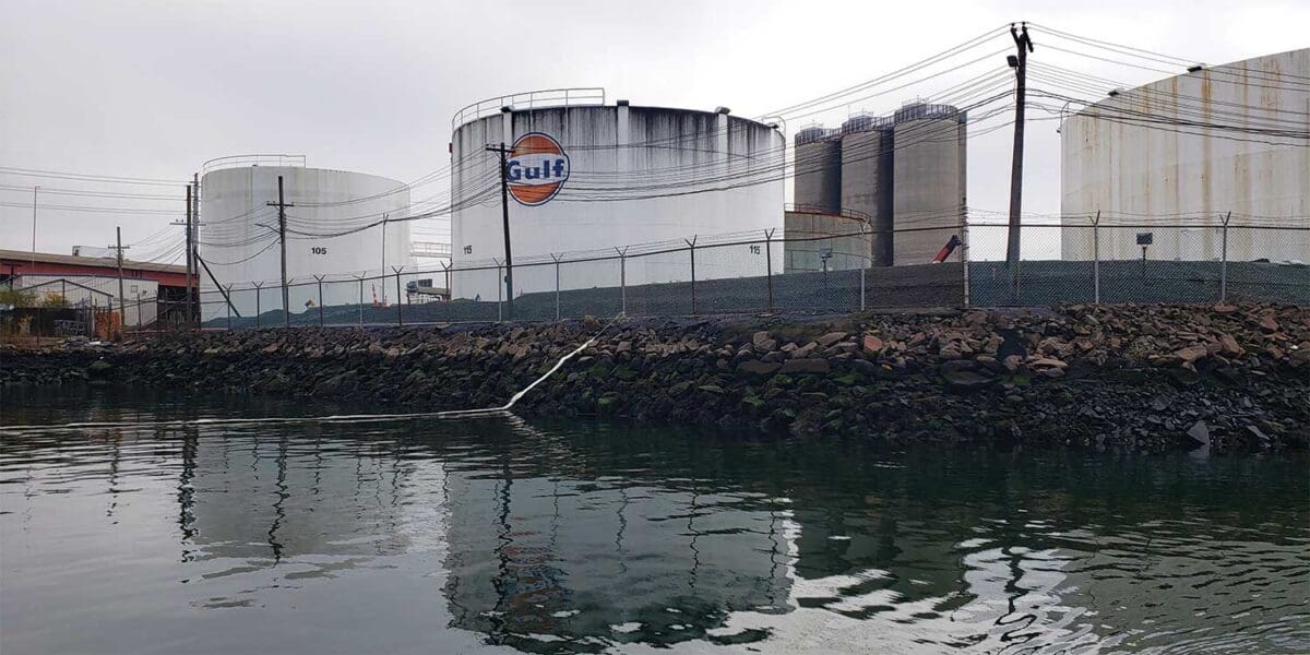 Oil terminal with the Gulf logo sits close to the water