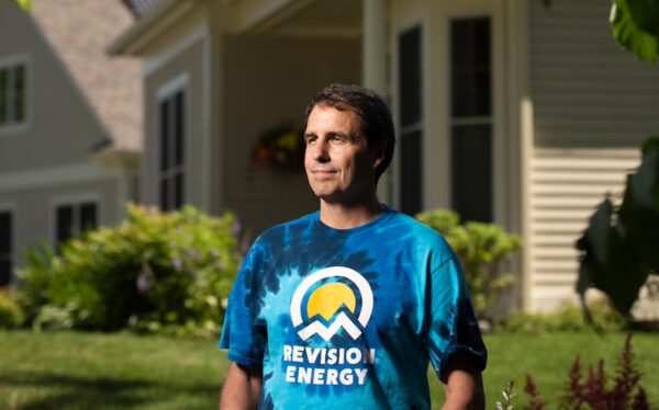 Photo of Phil Coupe, white male, standing before a home.