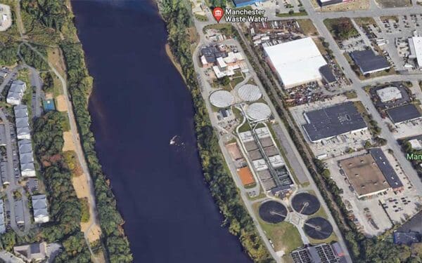 An aerial view of a river with industry lining both shores