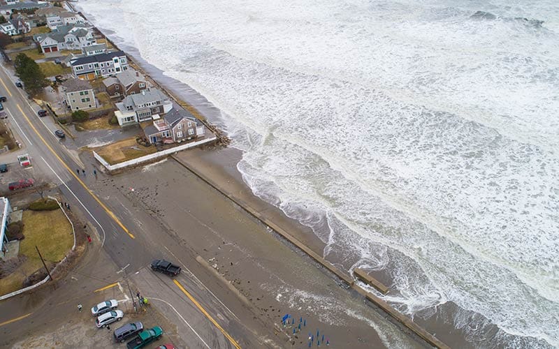 High sea levels flooding houses and a street