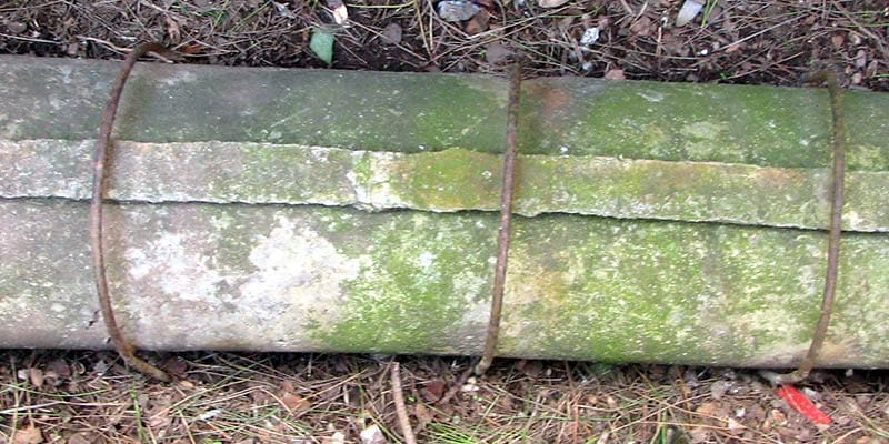 Ancient Roman lead water pipe unearthed in Ostia Antica, bound with iron bands – demonstrating early plumbing infrastructure that contributed to lead exposure in historic civilizations.