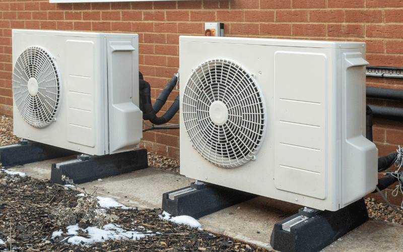Two air source heat pump units installed on a modern house