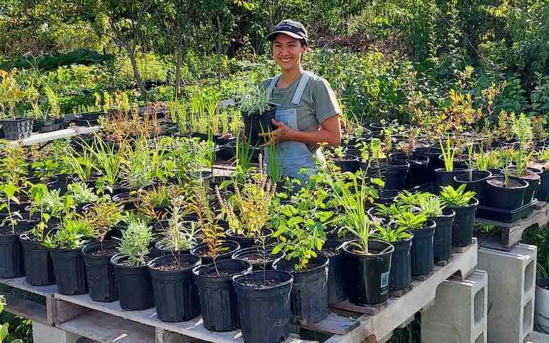 Sam Olvera holding plant in nursery