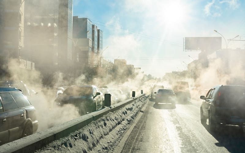 a smoggy highway in winter filled with car exhaust