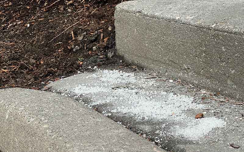 Excessive road salt covering a worn concrete step